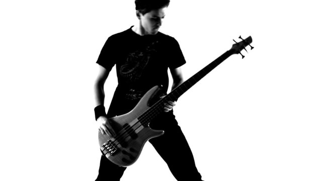 Fan of metal playing guitar. Black and white video.