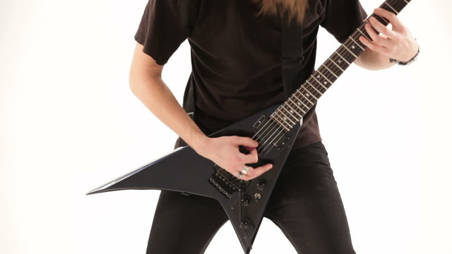 Metal musician playing electric guitar. Close-up.