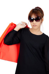 Isolated young asian woman carries shopping bags
