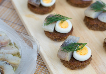 Canapes with herring and eggs