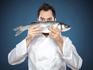Male chef with seabass fish