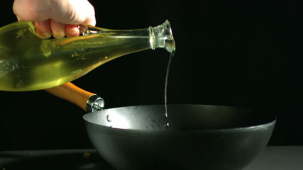Olive oil being poured into wok - Powered by Adobe