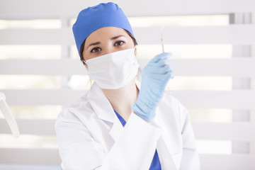 Fototapeta premium Happy female doctor checking her instruments before surgery