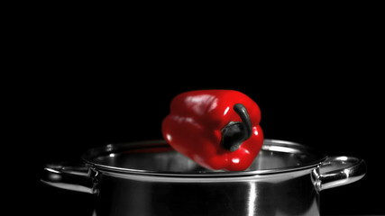 Red pepper falling into a pot - Powered by Adobe