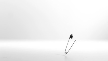 Open safety pin falling and pin vibrating - Powered by Adobe