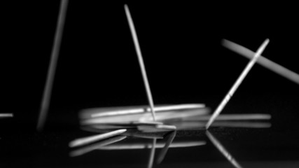 Cocktail sticks falling in black and white - Powered by Adobe