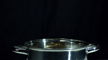 Turnip falling in saucepan on black background - Powered by Adobe