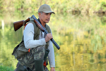 Hunter stood by the river