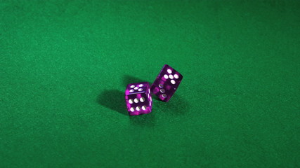 Purple dice rolling on green table in slow motion - Powered by Adobe
