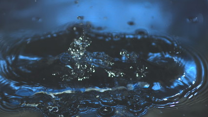 blue toothbrush falling in water in slow motion - Powered by Adobe