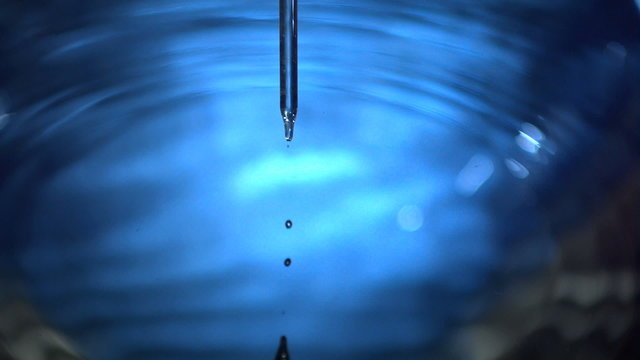 Droplet falling off a pipette in super slow motion
