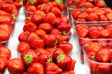 Fresh strawberries for sale in plastic containers