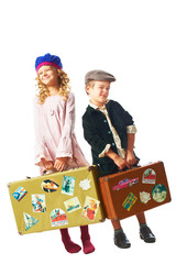 little boy and girl standing with suitcase in hand
