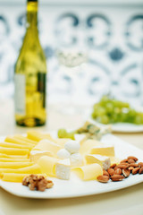 sliced cheese with wine and nuts