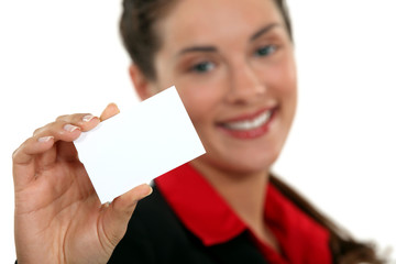 A businesswoman handing her card.