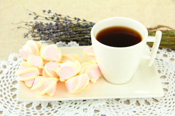 Marshmallows on plate on light background