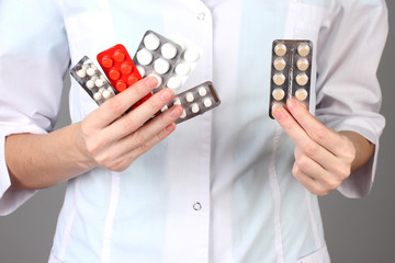 Close-up of female doctor hand holding pills,