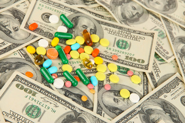 Pills and money close-up background