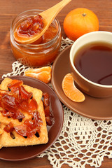 light breakfast with tea and homemade jam, on wooden table