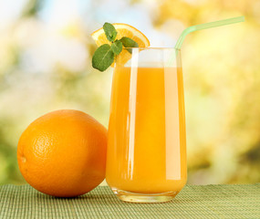 Glass of orange juice with mint and orange