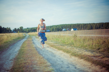 Image of young running woman on the road