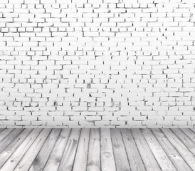 interior room with white brick wall and wooden floor