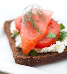 Red fish canape with cream cheese and tomato