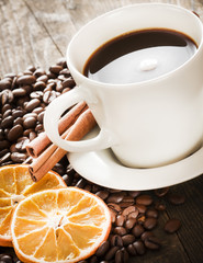 Coffee tastefully presented, next to coffee beans.