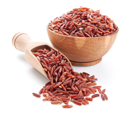 red rice in a wooden bowl isolated on white - 48873755