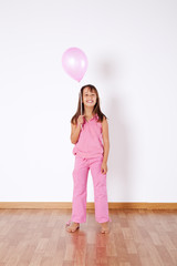 Little girl holding color ballons