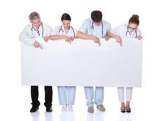 Medical staff holding up a white banner