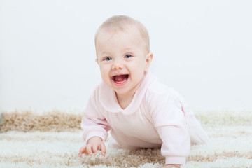 baby girl creeping on the carpet