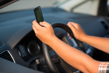 Fototapeta na wymiar Texting and talking while driving