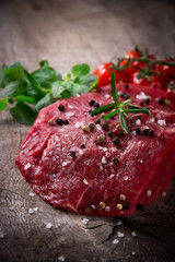 Raw beef steak on wooden table
