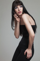 Naklejka premium Fashion model with long dark hair.