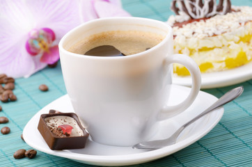Coffee cup and milk chocolate candy  closeup