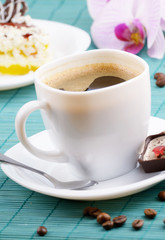 Coffee cup and milk chocolate candy  closeup
