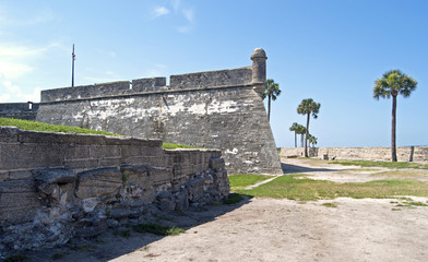 Fototapeta na wymiar Tower, walls and field of an old fort, St. Augustine, FL.