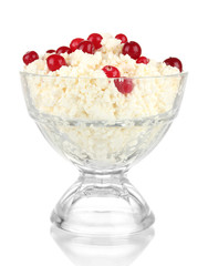 Cottage cheese in  glass bowl with red berries, isolated