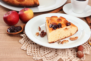 slice of tasty homemade pie with jam and apples and cup of