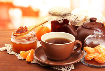 light breakfast with tea and homemade jam, on wooden table