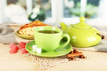cup of tea with scarf on table in room
