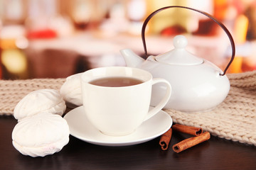 cup of tea with scarf on table in room