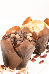 Blueberry muffin and chocolate muffin on white