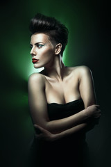 Naklejka premium beautiful woman with red lips in green light