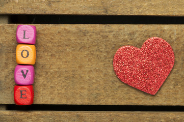 Word love on multicolored wooden cubes on wooden background