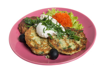 Roasted cutlets of potato with salmon on a plate
