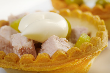 tartlet with salad on a white plate