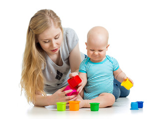 baby boy and mother playing together with cup toys