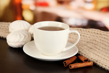 cup of tea with scarf on table in room